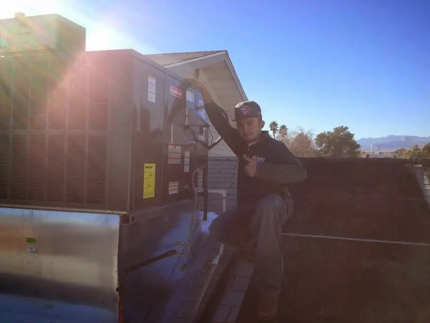 HVAC technician performing HVAC Inspection on a rooftop unit in Kill Devil Hills